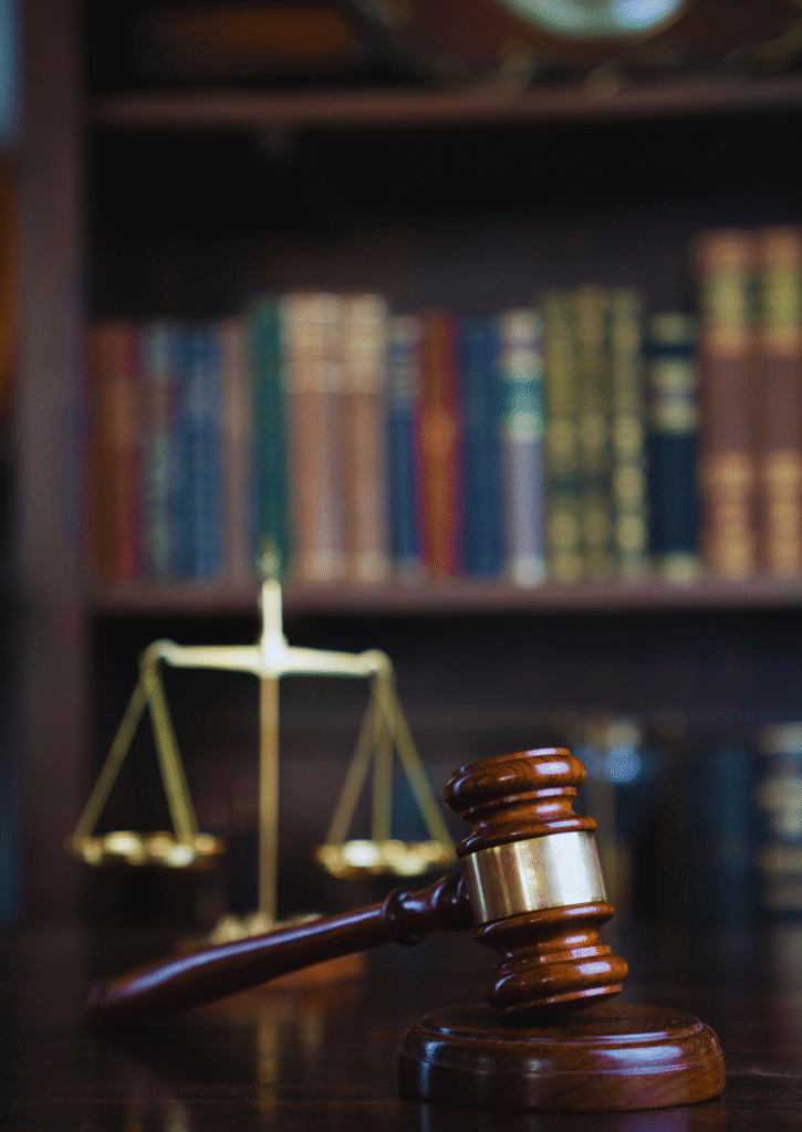Gavel and scales of justice in front of law books